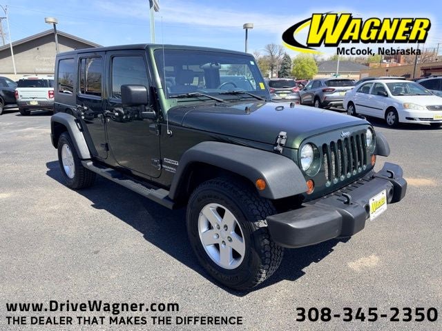 2010 Jeep Wrangler Unlimited Sport in Natural Green Pearlcoat — front three-quarter view